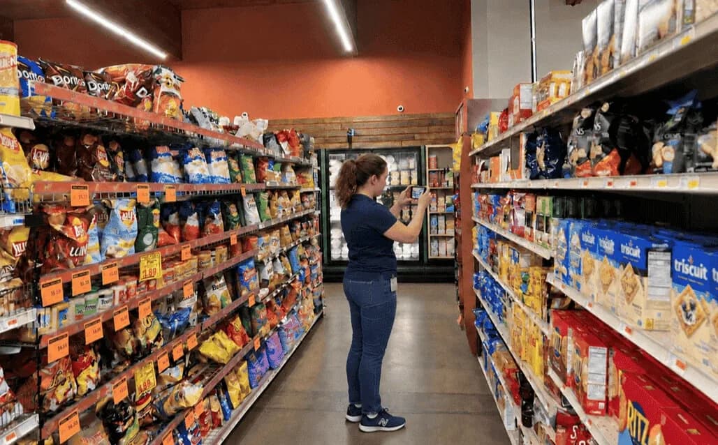 Retail auditor capturing shelf photo